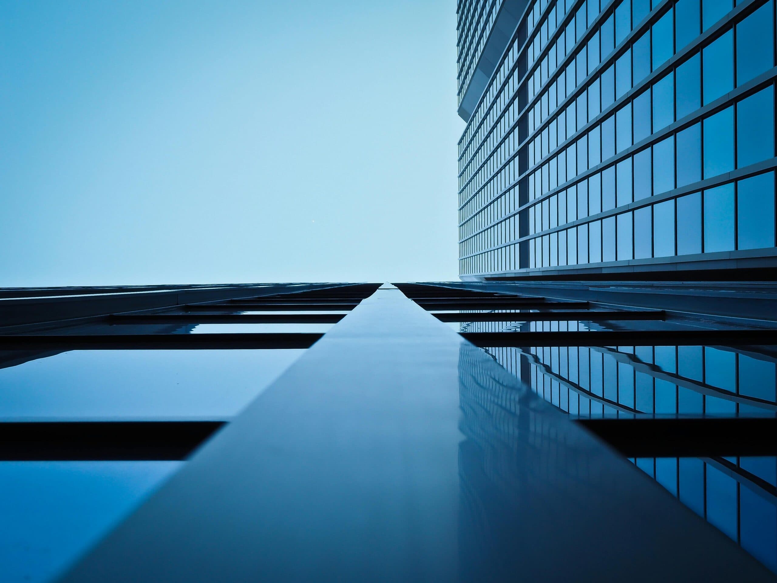 Modern glass office tower viewed from below